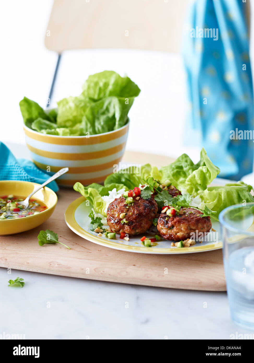 Plate of Thai prawn cakes with lettuce and dipping sauce Stock Photo