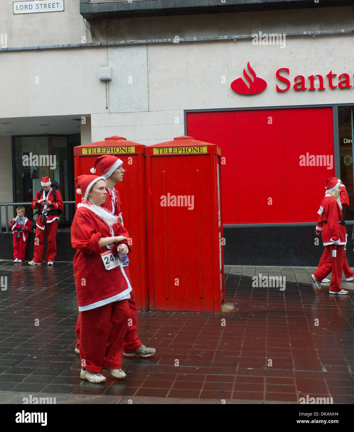 Charity Santa Dash In Liverpool Santas Outside Santander Stock