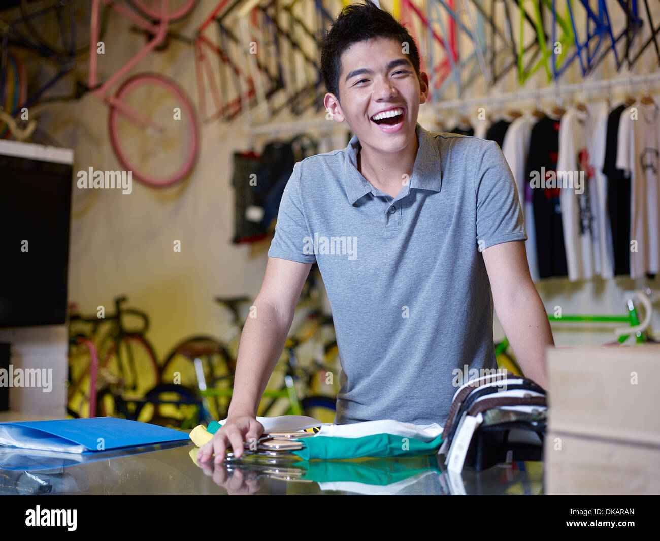 Portrait of young man laughing in bike shop Stock Photo