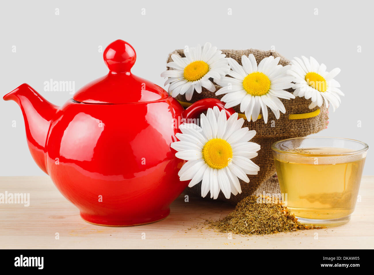 healthy chamomile tea, red teapot and sack with daisies Stock Photo Alamy