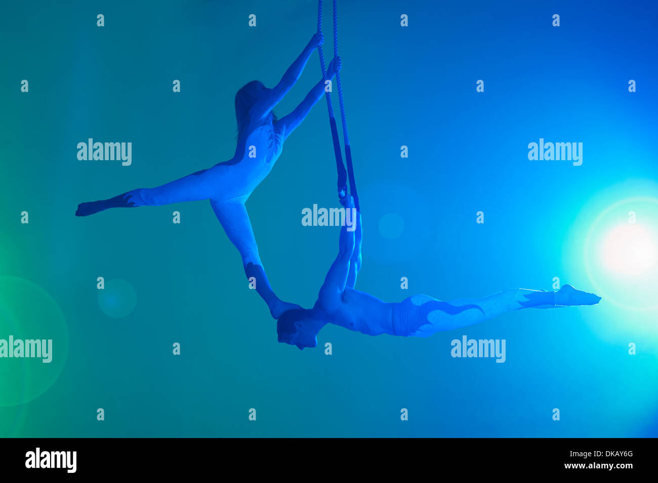 Couple on trapeze Stock Photo