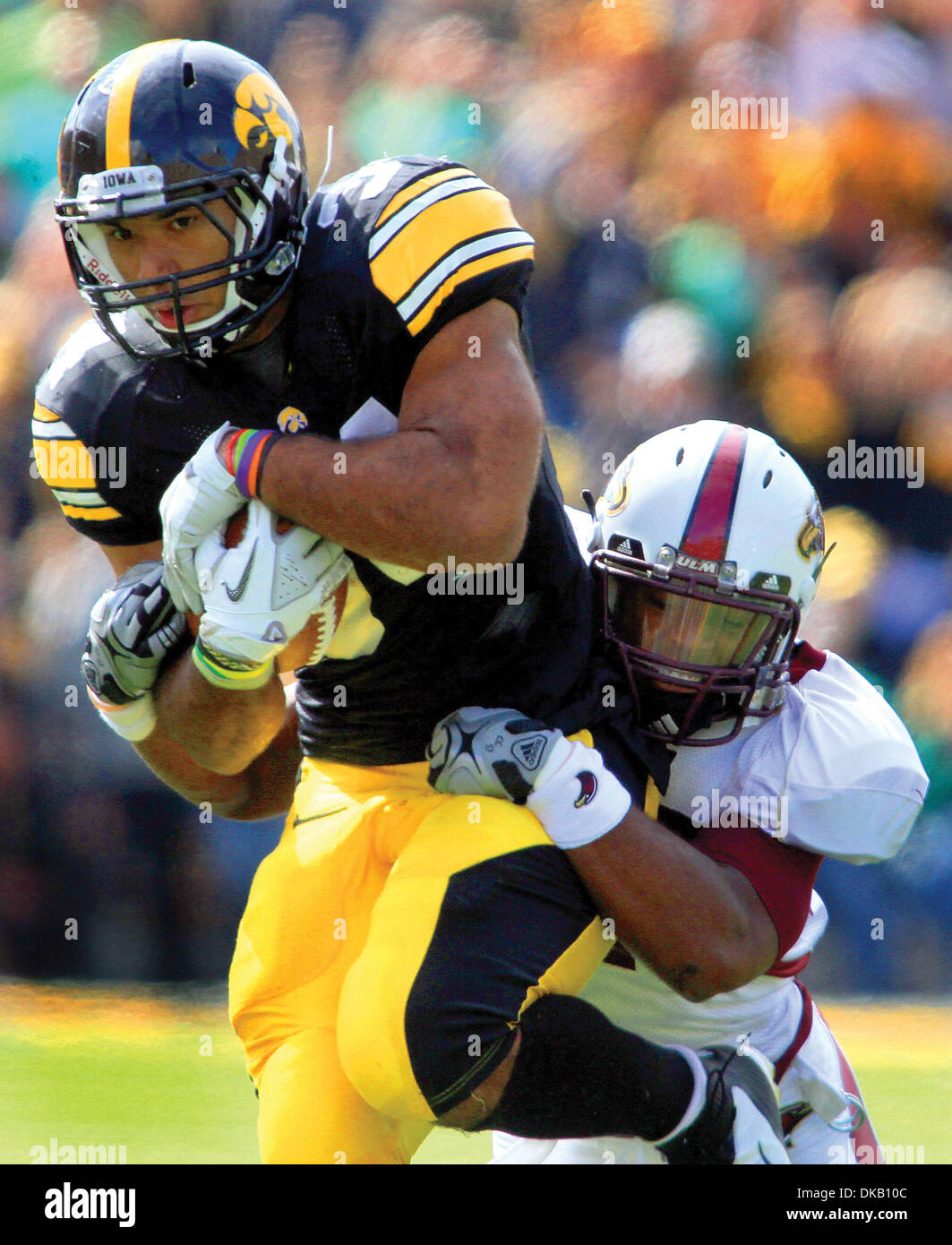 Sept. 24, 2011 - Iowa City, Iowa, U.S. - Iowa's Marcus Coker gets dragged down by University of Louisiana Monroe's Darius Prelow after picking up yards on a second attempt, Saturday, September 24, 2011, during first half action at Kinnick Stadium in Iowa City. (Credit Image: © John Schultz/Quad-City Times/ZUMAPRESS.com) Stock Photo
