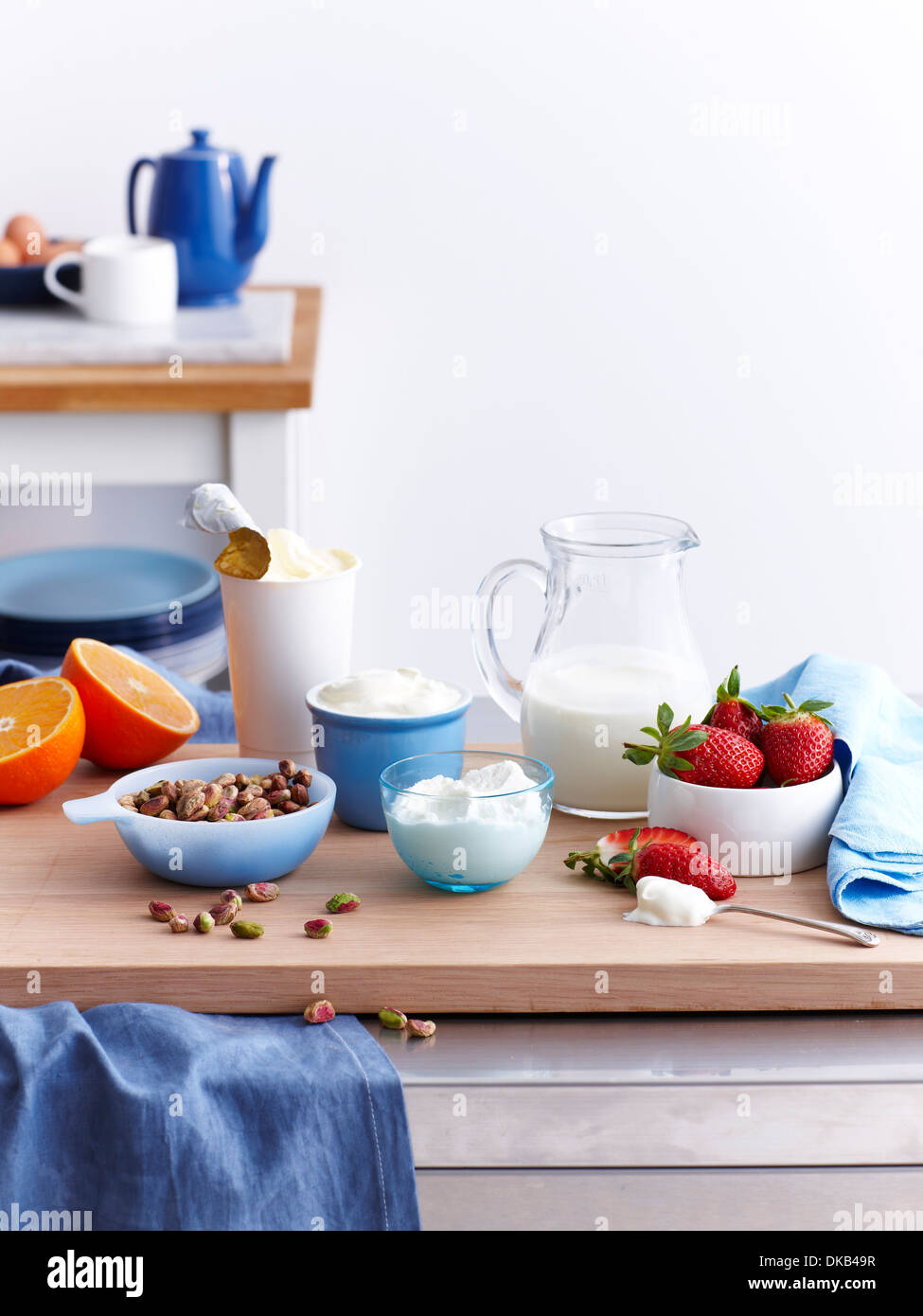Fresh foods laid out for breakfast with nuts, fruit and milk Stock Photo