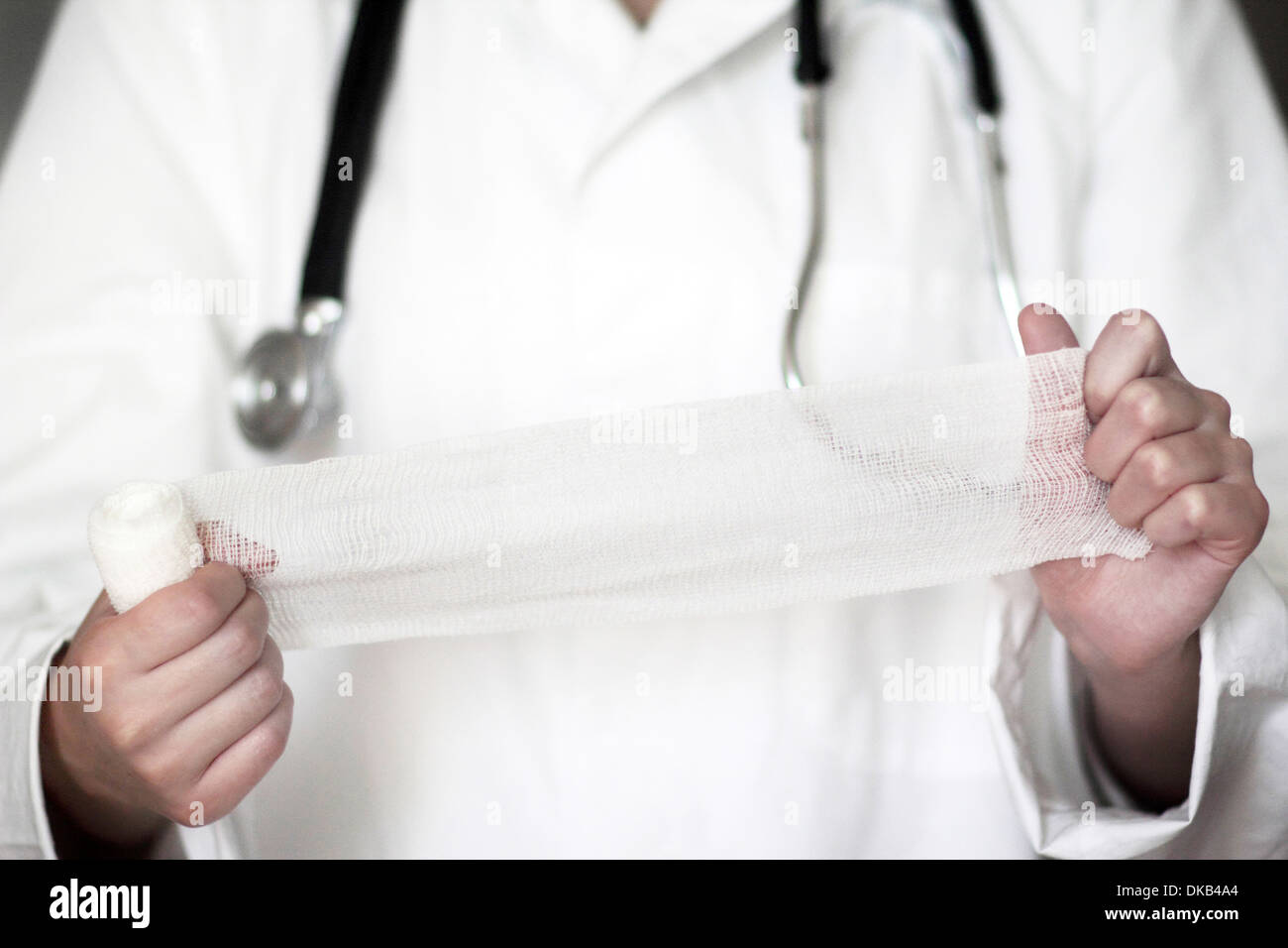 Close up studio shot of female doctor holding bandage Stock Photo