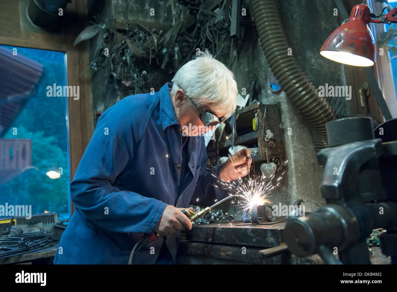 Welder with protective mask welding metal and sparks Stock Photo