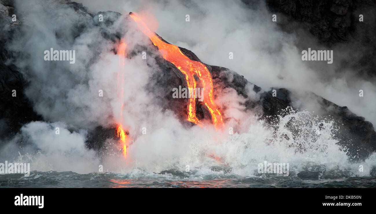 Hot lava stream is flowing into the ocean. Hawaii, Big Island. Stock Photo