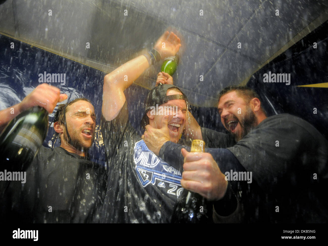 Sep. 29, 2011 - St. Petersburg, Florida, USA.Tampa Bay Rays' Evan Longoria (C) celebrates with teammates Sam Fuld (L) and Kelly Shoppach (R) in the clubhouse following his 12th inning home run to beat the New York Yankees 8-7 and secure the American League wild card during a Major League Baseball game in St. Petersburg, Florida, USA  29 September 2011. (Credit Image: Brian Blanco/Z Stock Photo
