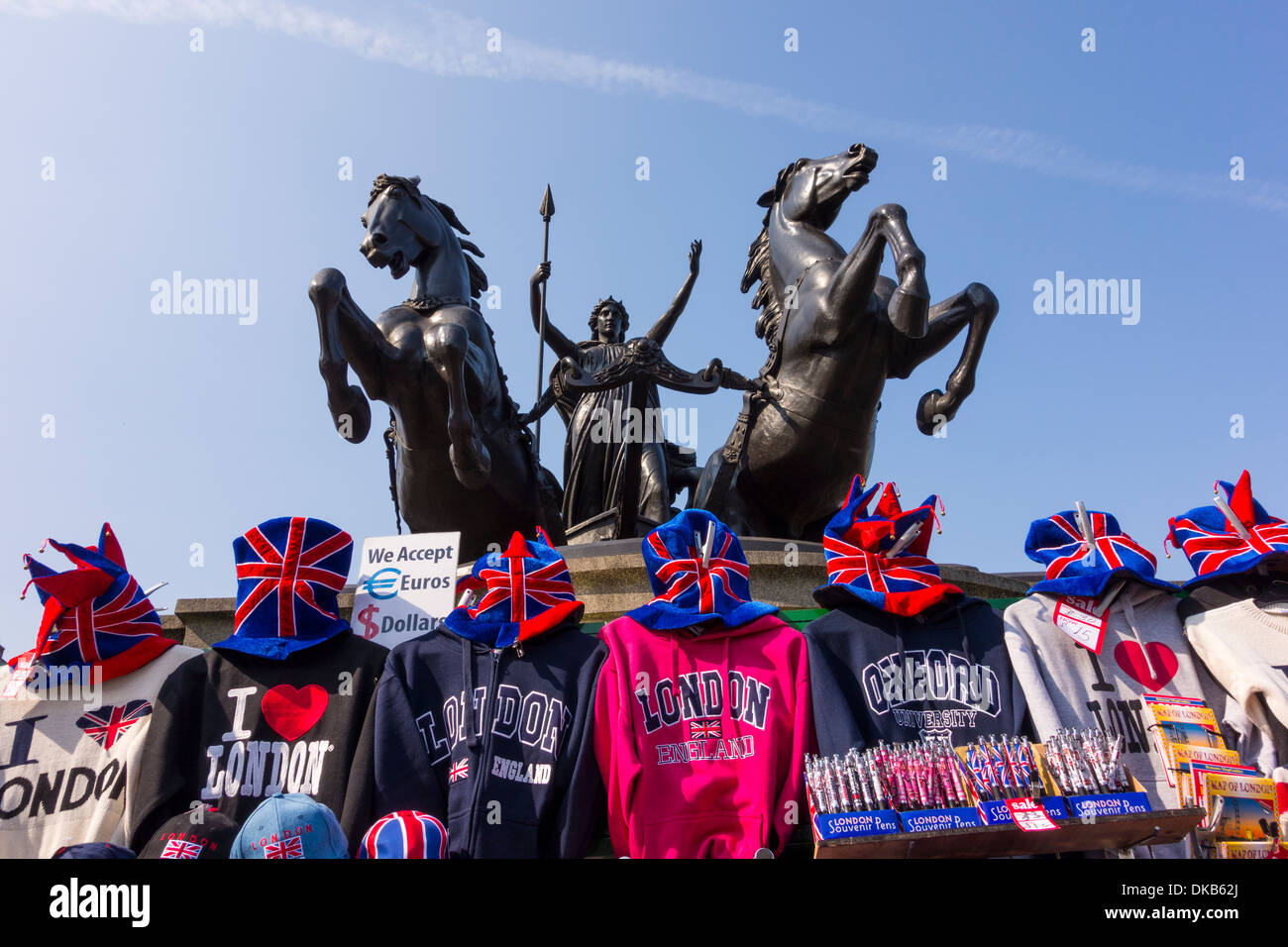 Display of I Love London souvenir t-shirts and sweat shirts under Statue of Queen Boadicea on Chariot, London, UK Stock Photo