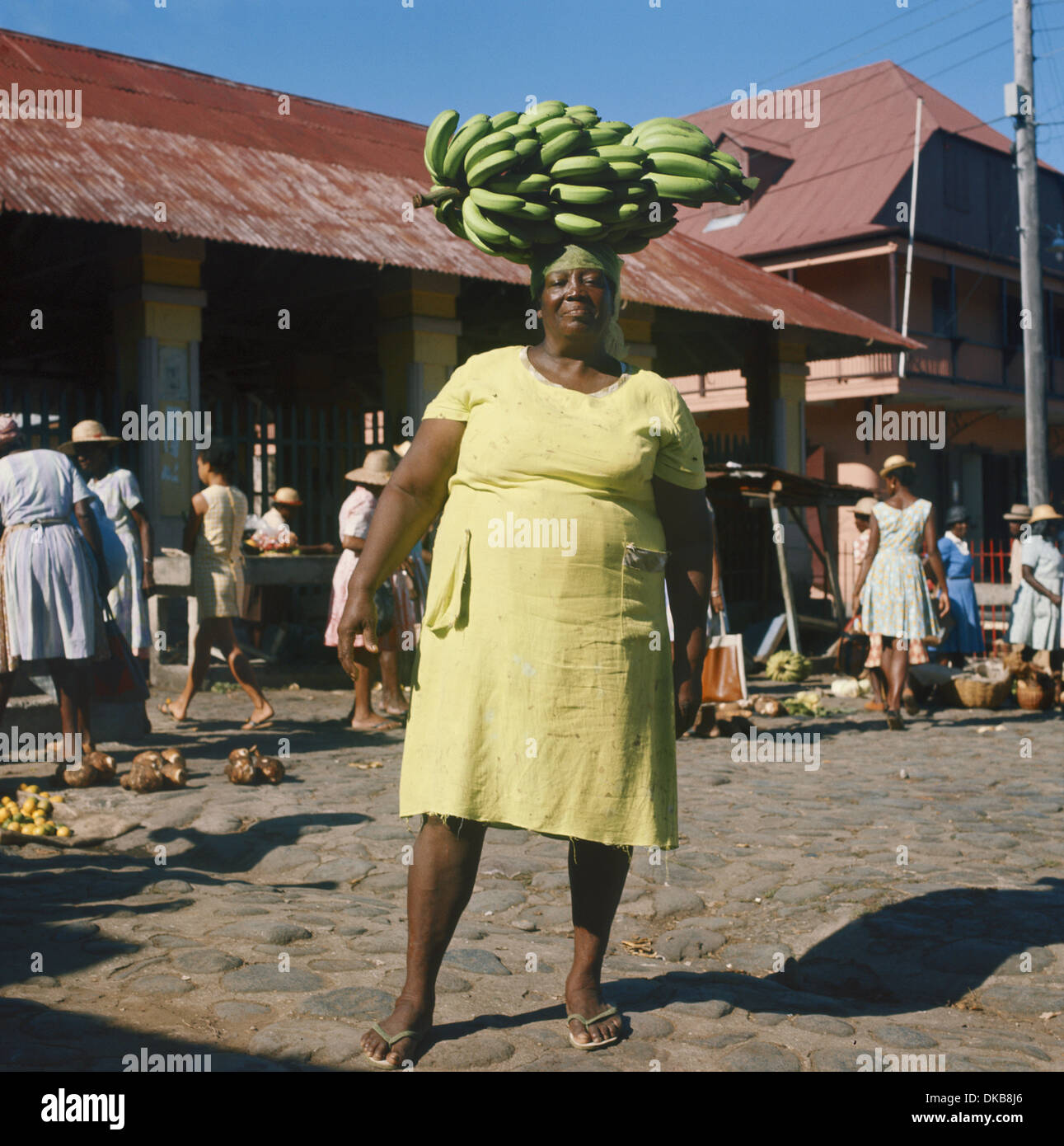 Dominica, Caribbean, Roseau market woman carrying a large stalk of