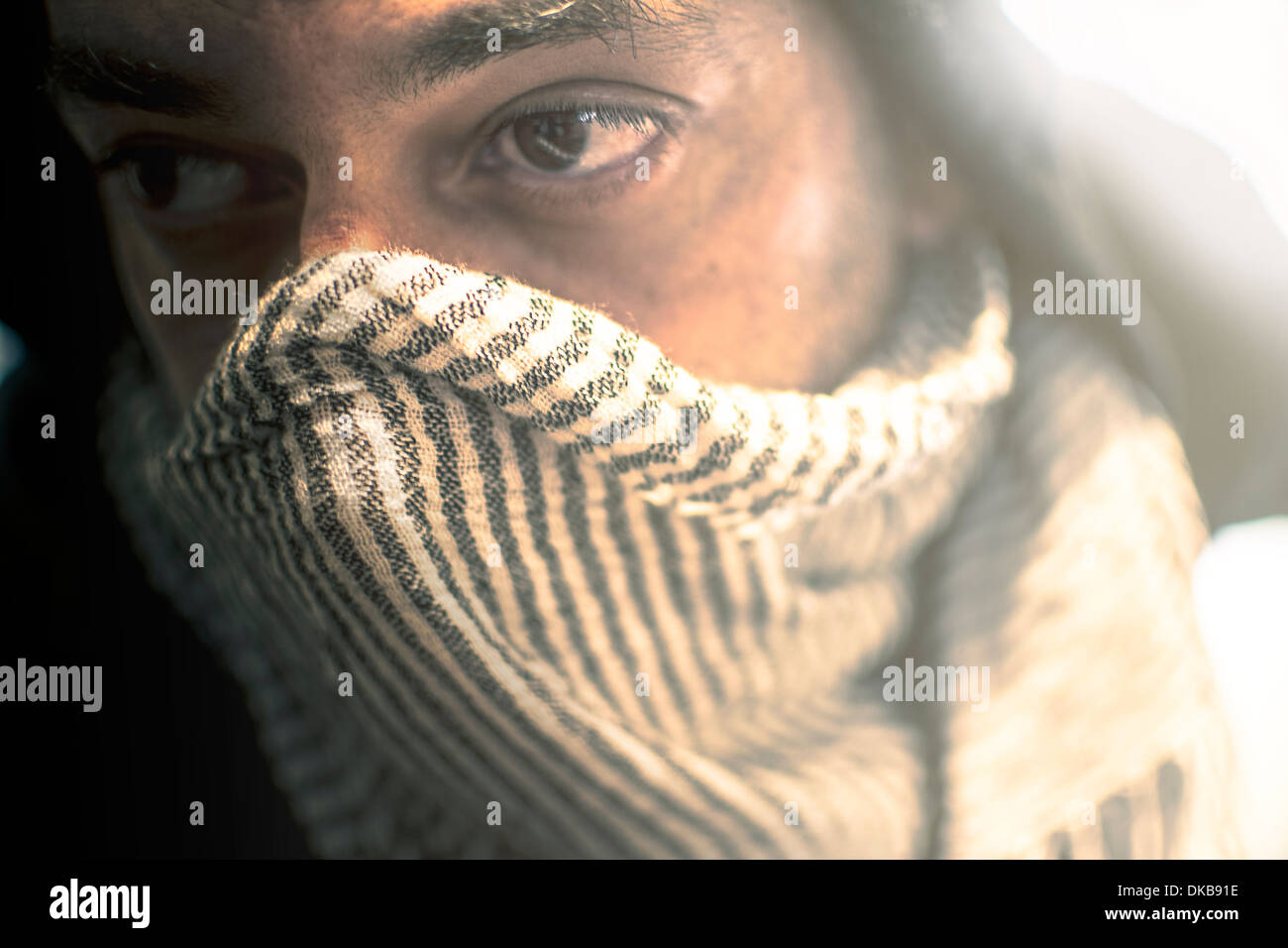 Close-up hoodie with scarf around his face Stock Photo