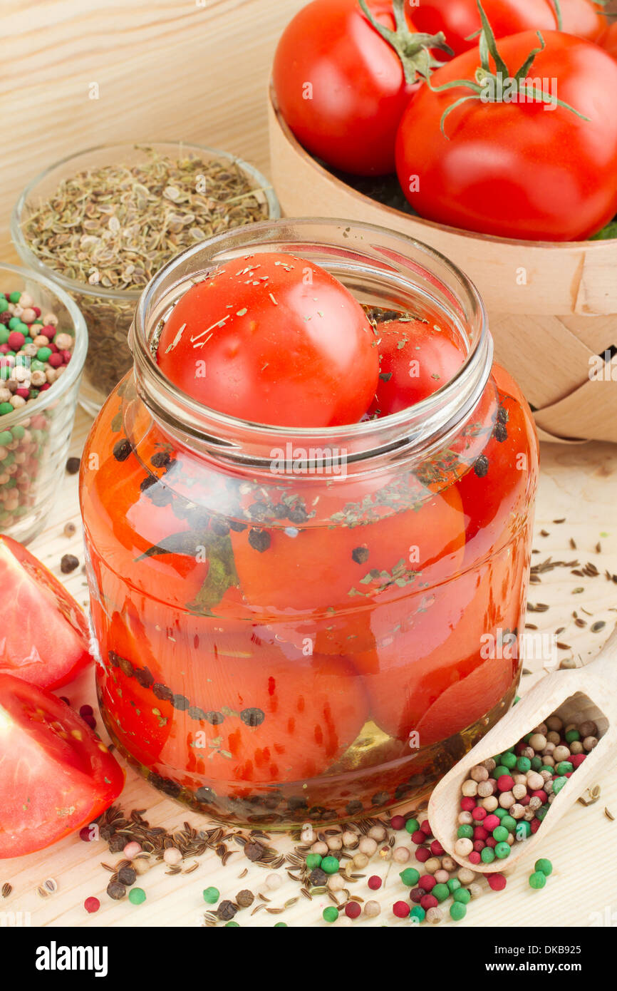 Homemade tomatoes preserves in glass jar. Canned tomatoes Stock Photo