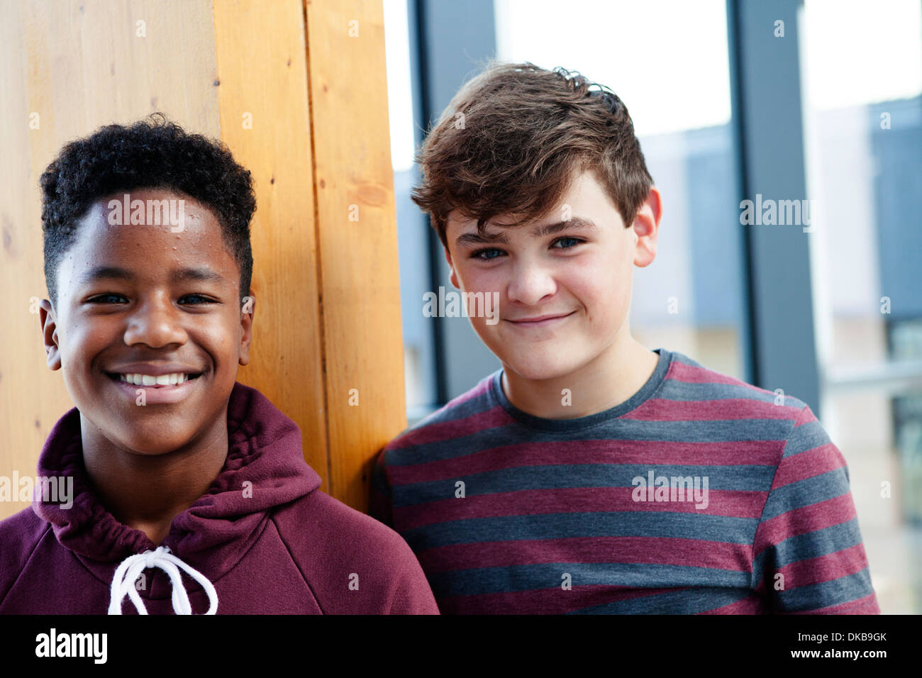 Portrait of two teenage schoolboys in corridor Stock Photo