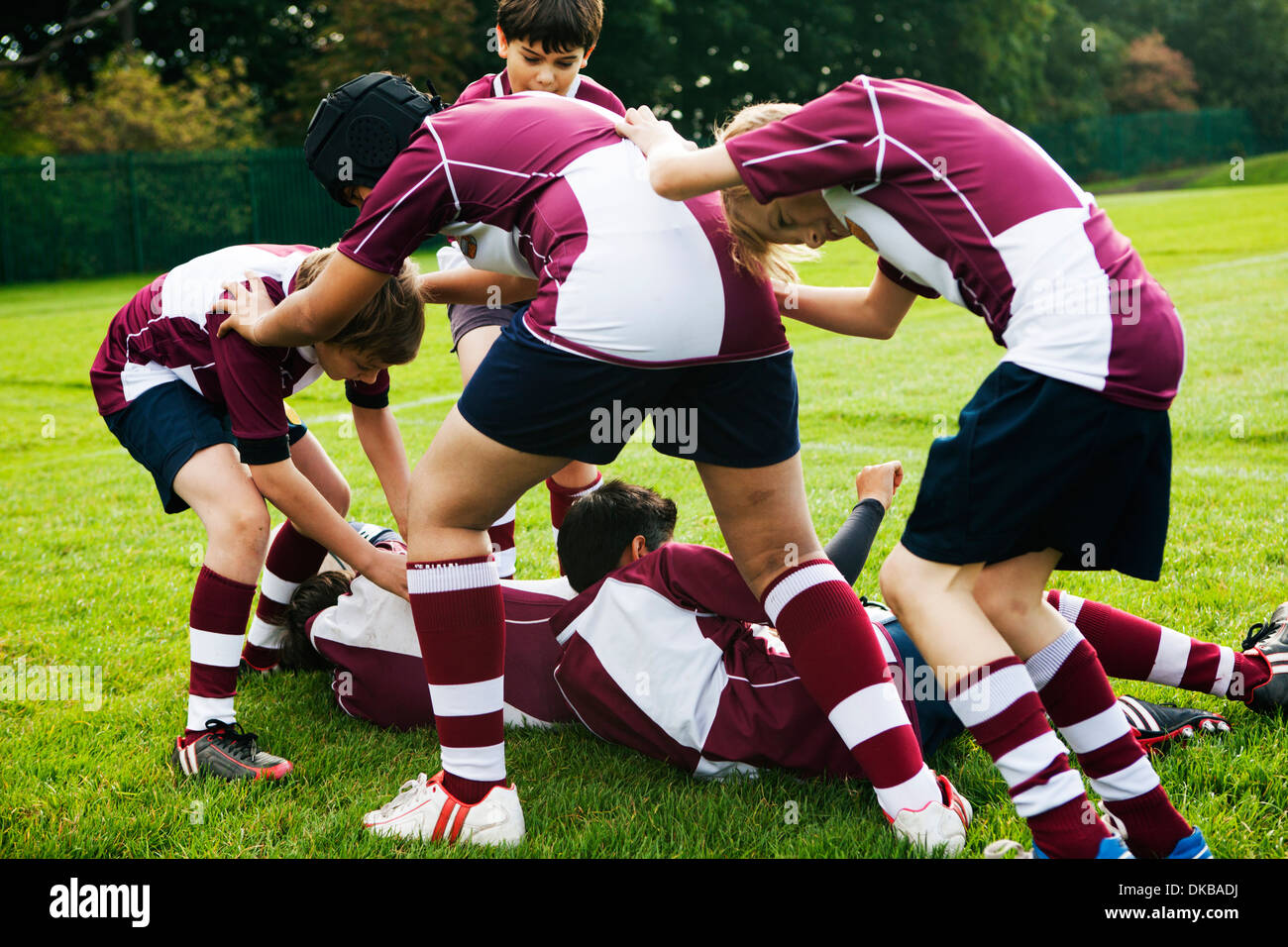Teenage schoolboy rugby team playing aggressively Stock Photo