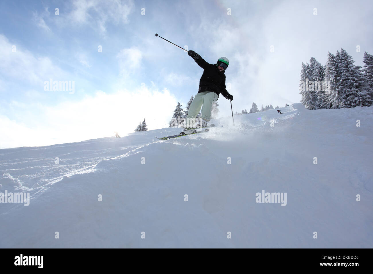 Skier going downhill Stock Photo