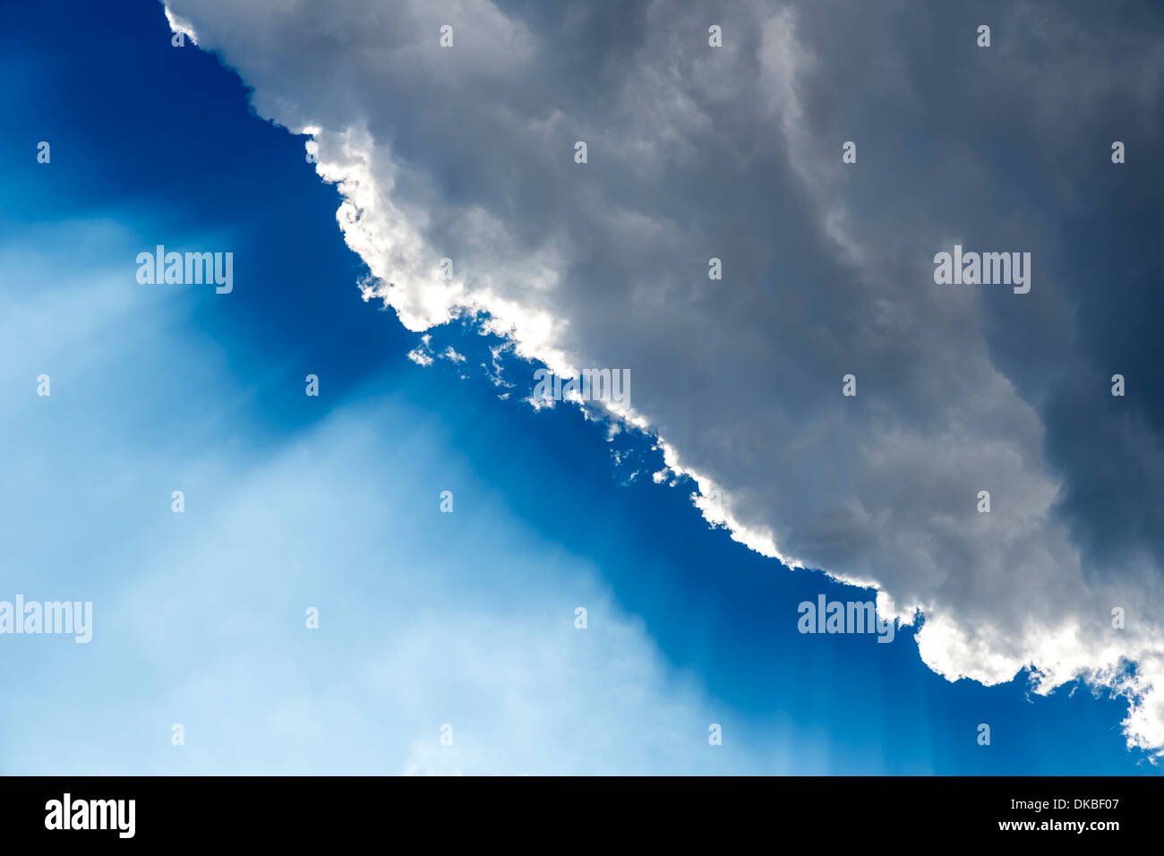 Cloud with sun's rays against blue sky Stock Photo