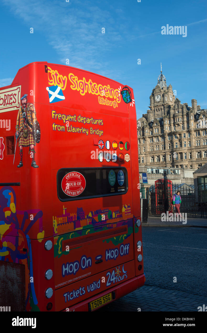 Double decker sightseeing bus parked with Balmoral Hotel in background. Edinburgh, Scotland. Stock Photo