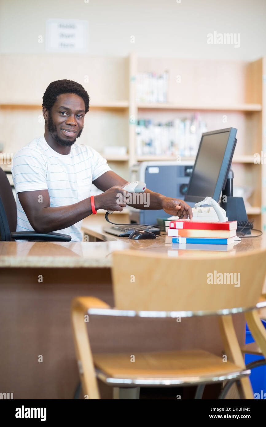 Librarian Scanning Books In Library Stock Photo Alamy
