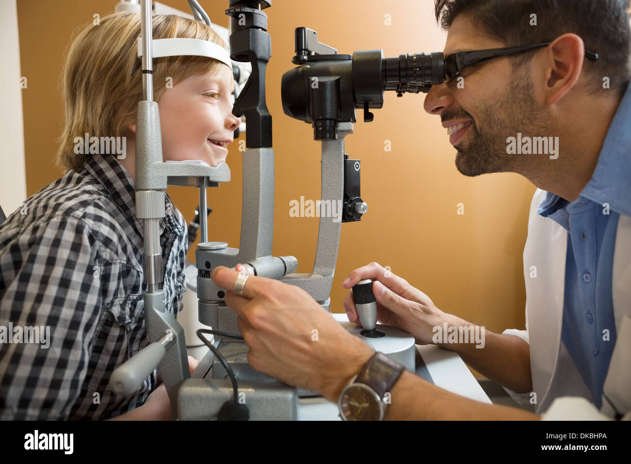 Optometrist Examining Boy's Eyes With Slit Lamp Stock Photo - Alamy