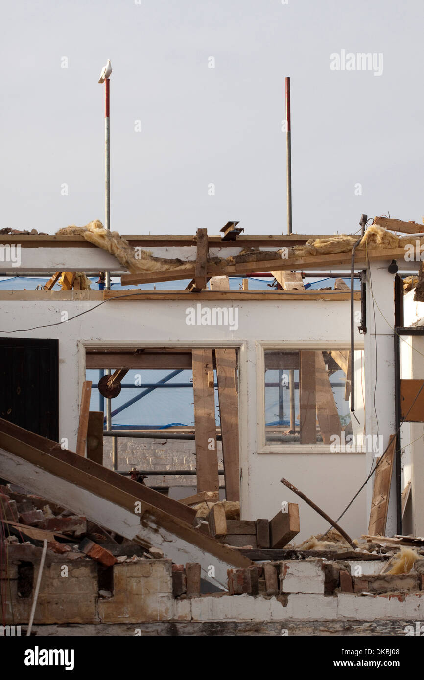 An interior room is revealed as a building is knocked down. Stock Photo