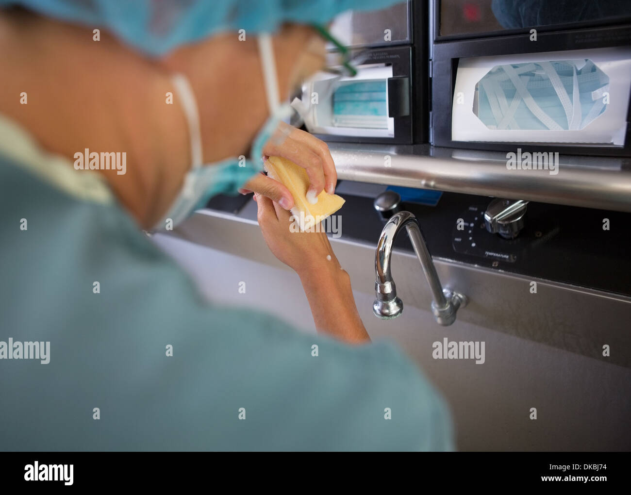 Surgeon washing hands before surgery hires stock photography and