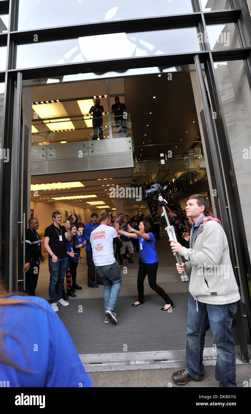 The first customers pick up newly released iPhone 5 at Apple's Regent Street store London England - 21.09.12 Stock Photo