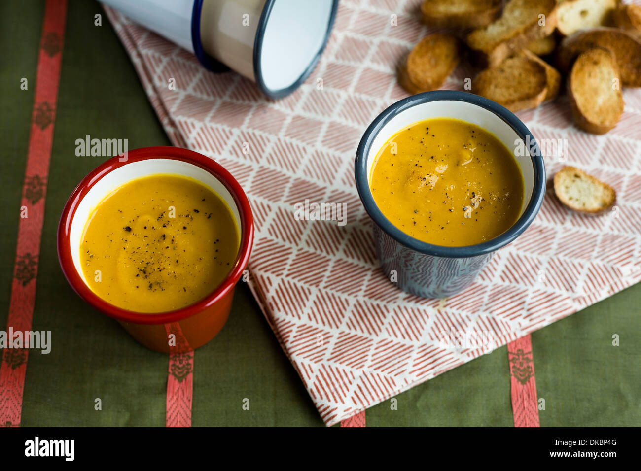 Two full metal cups of soup, vegetable, with toasted crouton Stock Photo Alamy