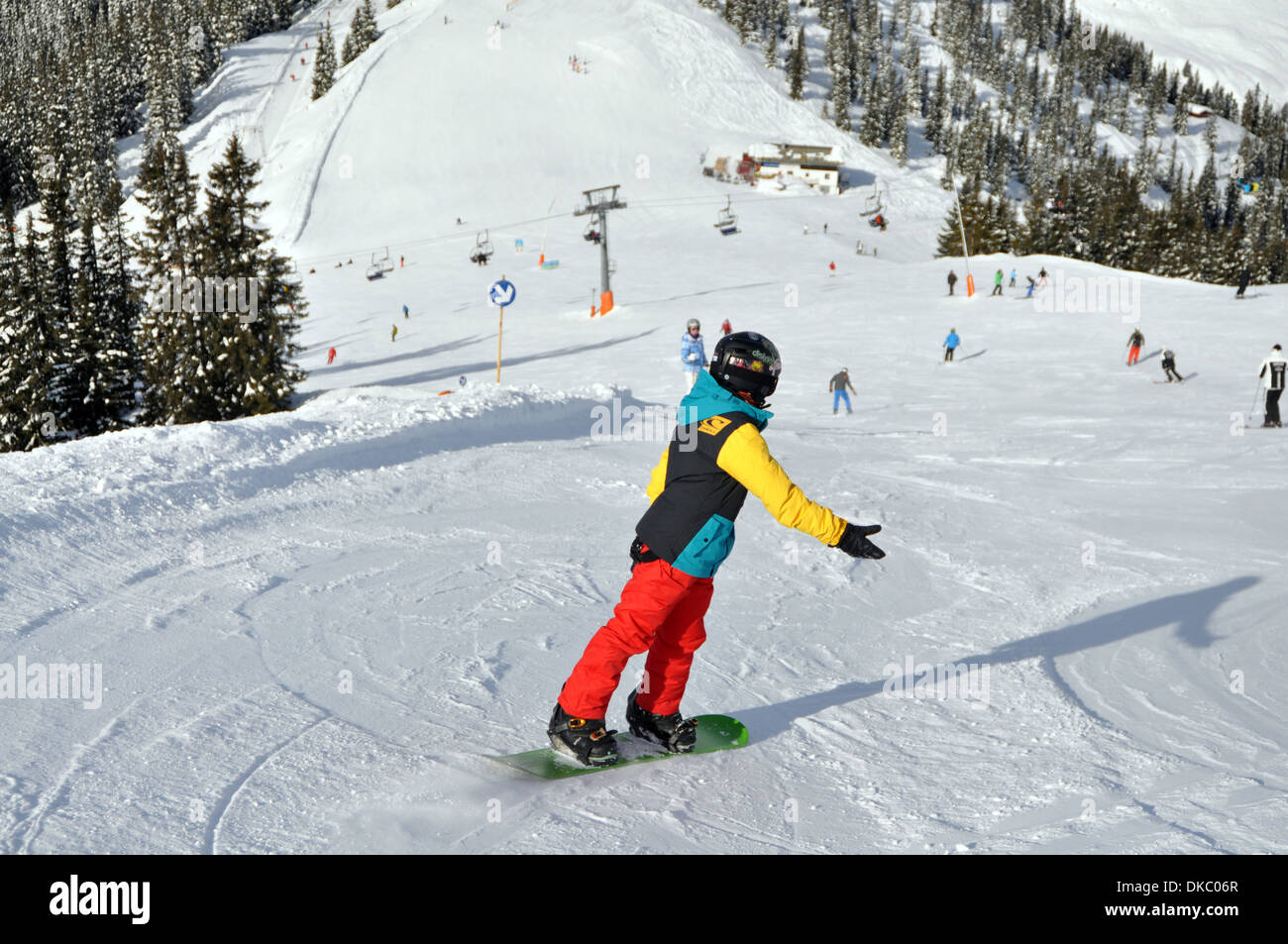 Snowboarding boy in Austrian Ski resort. Stock Photo