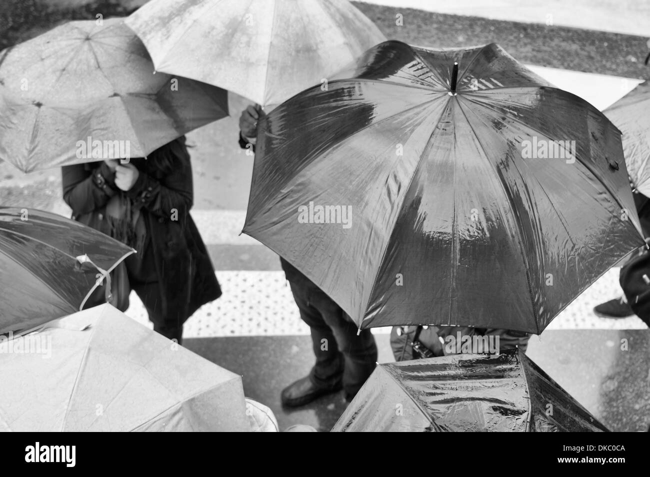 Paris, France - unidentifiable people with umbrellas in the rain Stock Photo