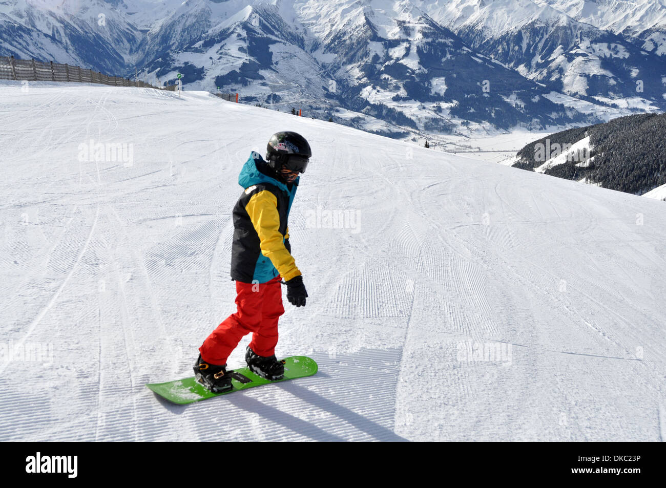 Snowboarding boy in Austrian Ski resort. Model released Stock Photo