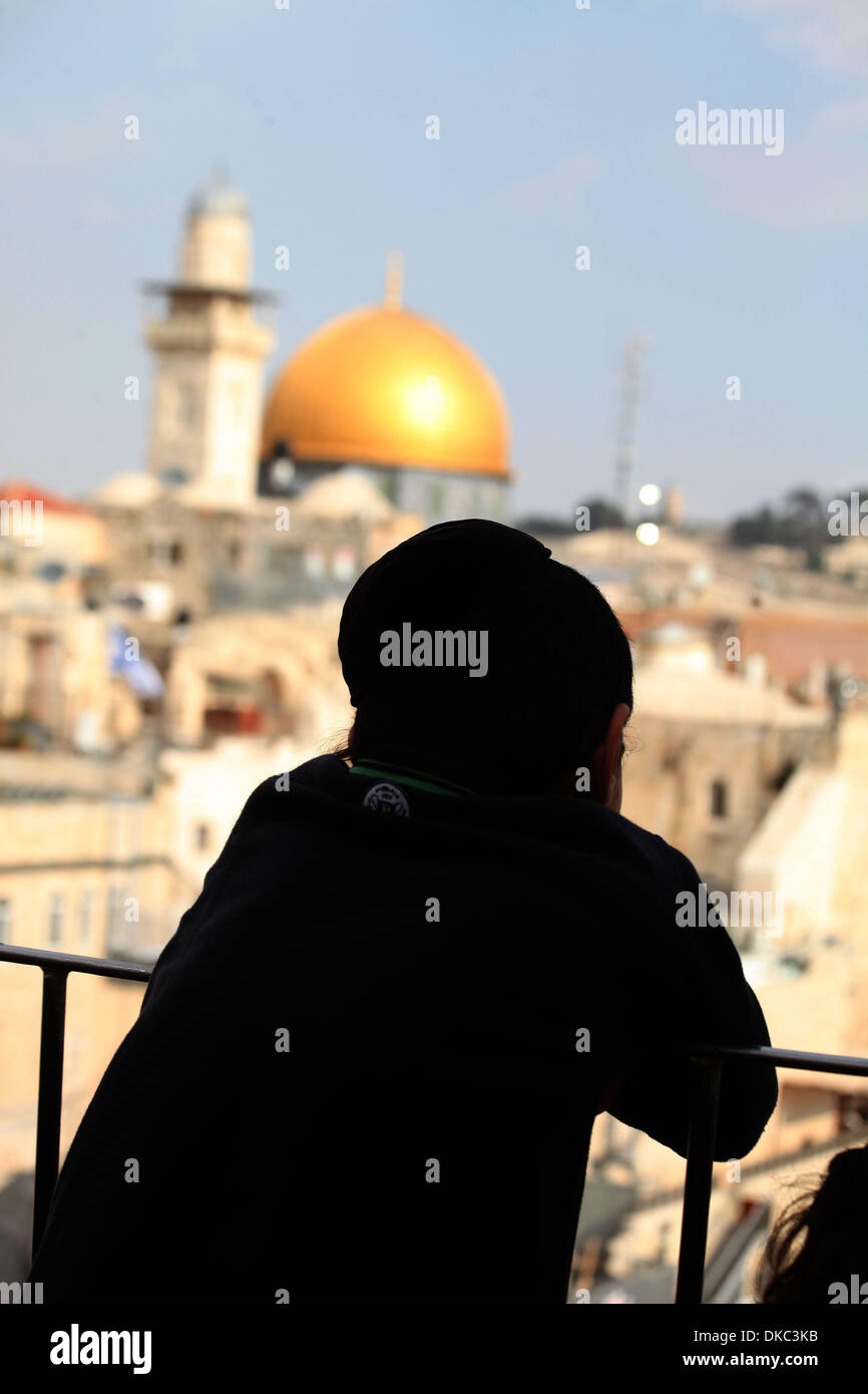 Jerusalem, Israel. 4th Dec, 2013. An Ultra-Orthodox Jewish looks on the Dome of The Rock mosque is seen December 4, 2013. during the Jewish holiday of Hanukkah, also known as the Festival of Lights, is one of the most important Jewish holidays and celebrated by Jews worldwide during eight days to commemorate the rededication of the Holy Temple in Jerusalem at the time of the Maccabean Revolt of the 2nd century BC.Photo: Saeed Qaq/NurPhoto © Saeed Qaq/NurPhoto/ZUMAPRESS.com/Alamy Live News Stock Photo