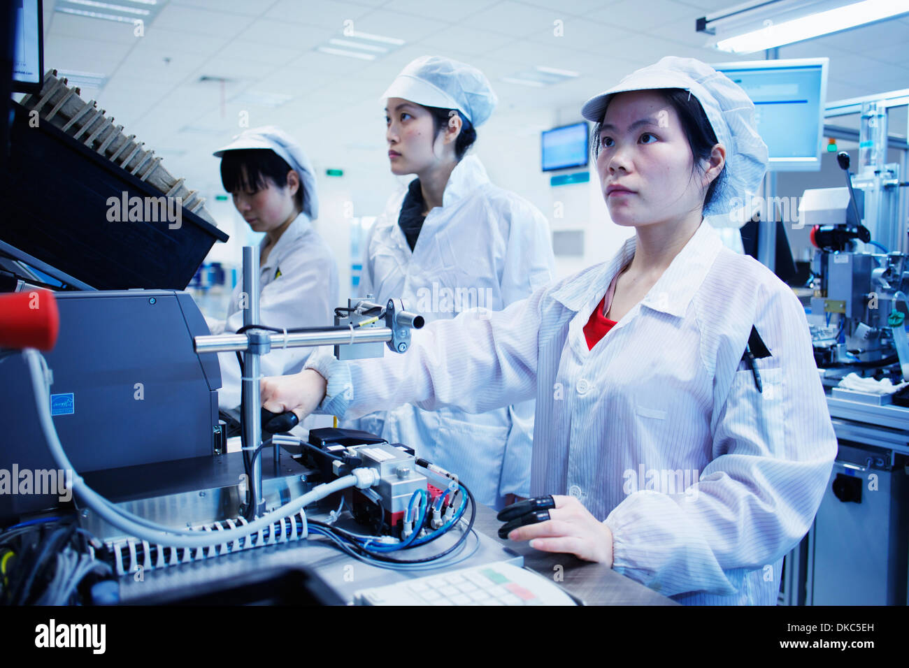Workers at small parts manufacturing factory in China Stock Photo