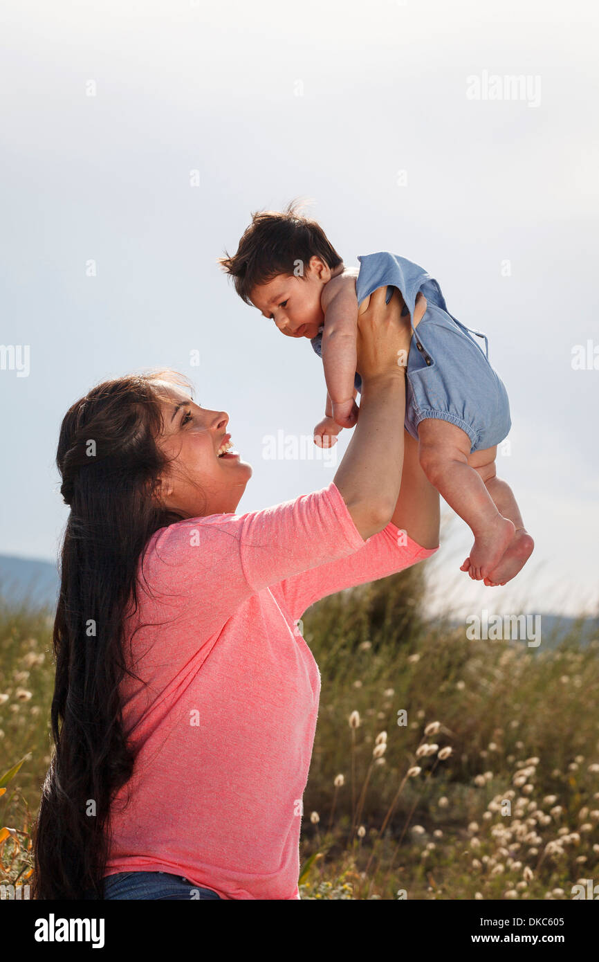 Mother holding baby in midair Stock Photo