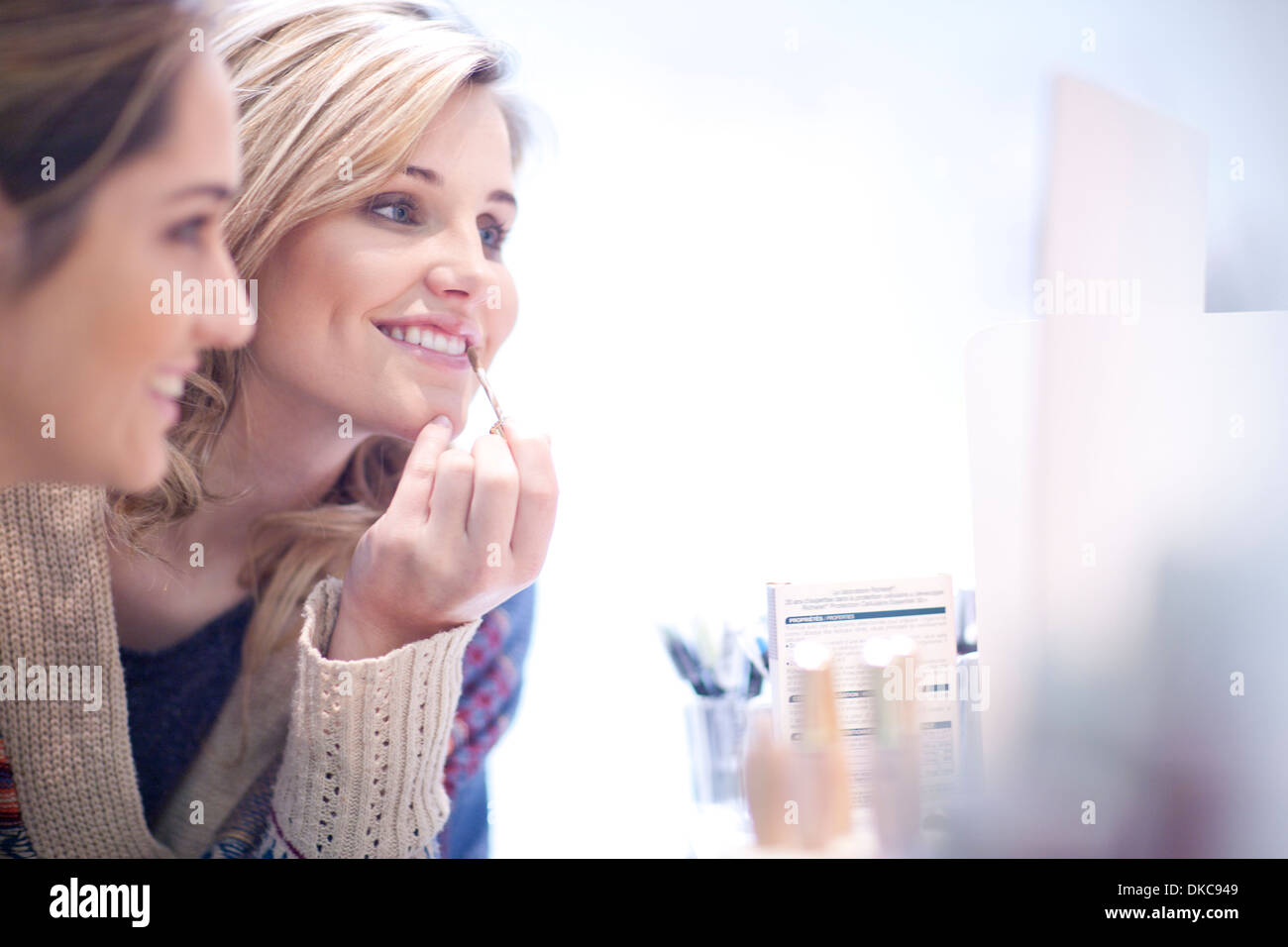 Young women applying make up Stock Photo