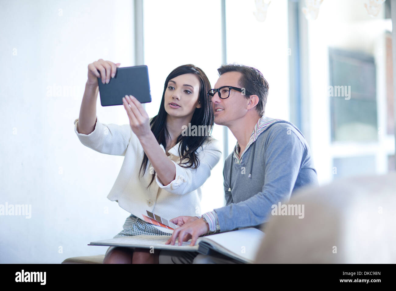 Interior designer and client looking at digital tablet Stock Photo