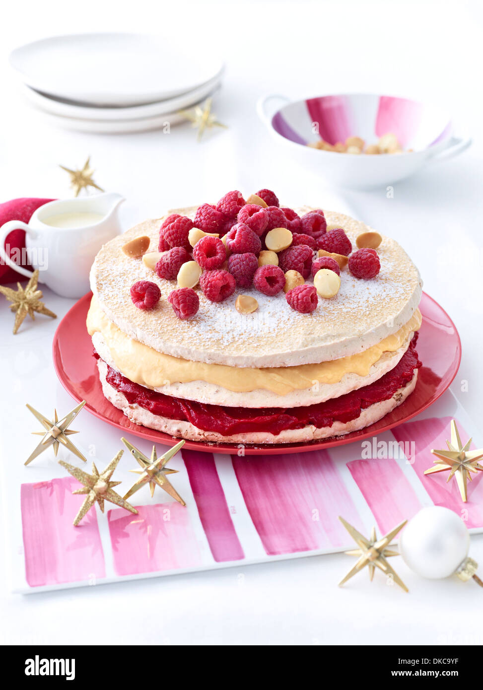 Meringue layer cake with raspberries and macadamia nuts Stock Photo