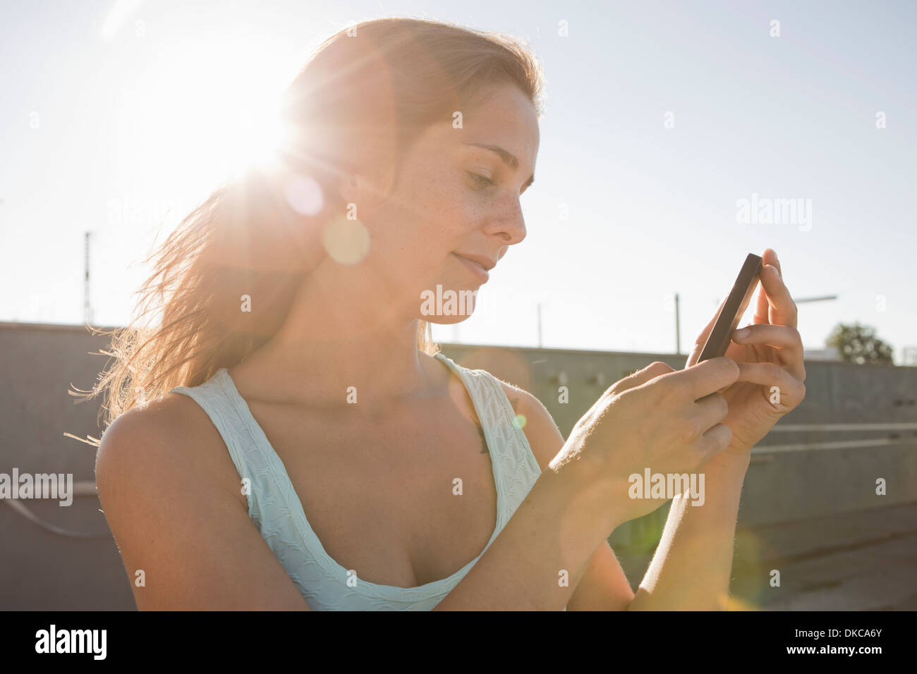 Portrait of young woman looking at mobile phone Stock Photo