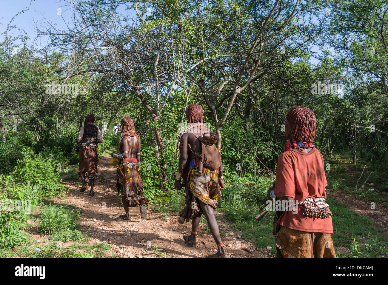 People going to a bull jumping ceremony. A rite of passage from boys to men. Hamer tribe, Omo valley, Ethiopia Stock Photo