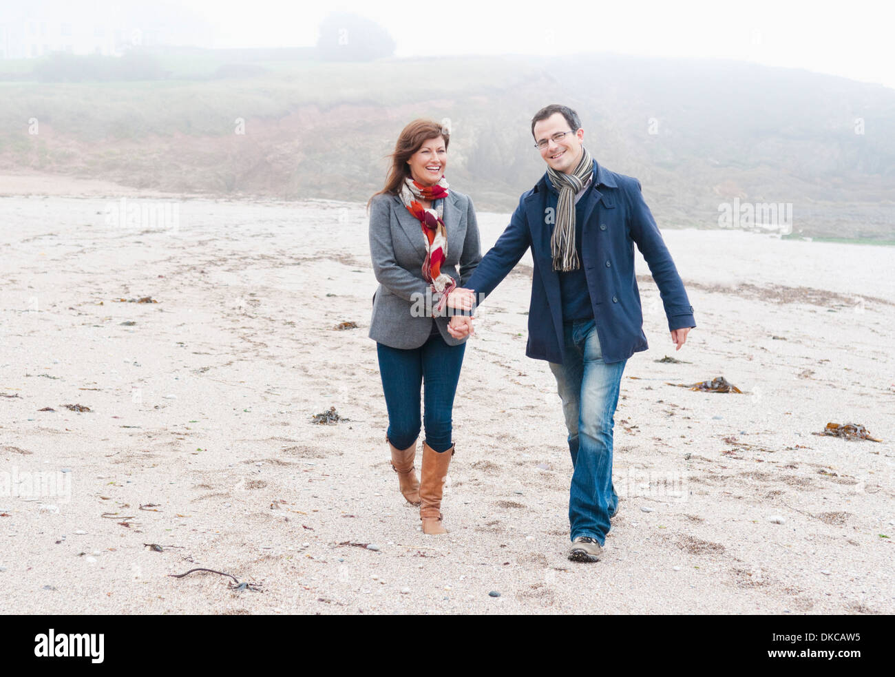 Couple walking on beach, Thurlestone, Devon, UK Stock Photo