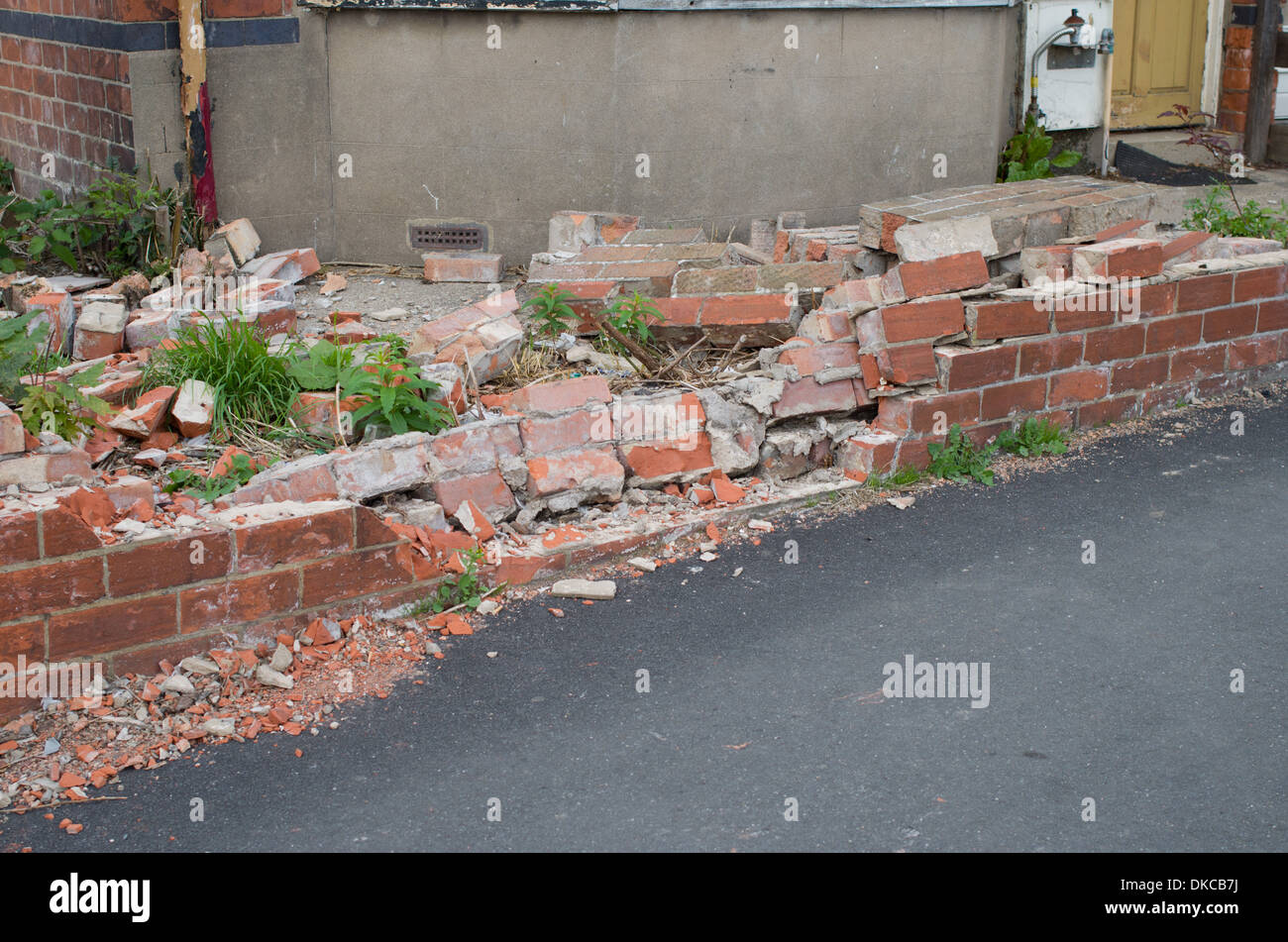 Front Garden wall of house suffering impact damage Stock Photo