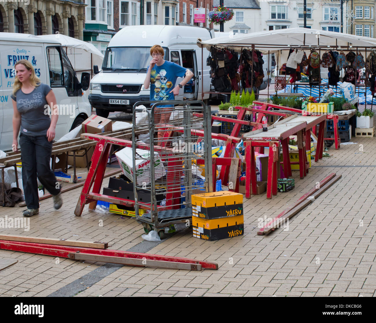 Market traders clear away and pack market stall UK Stock Photo