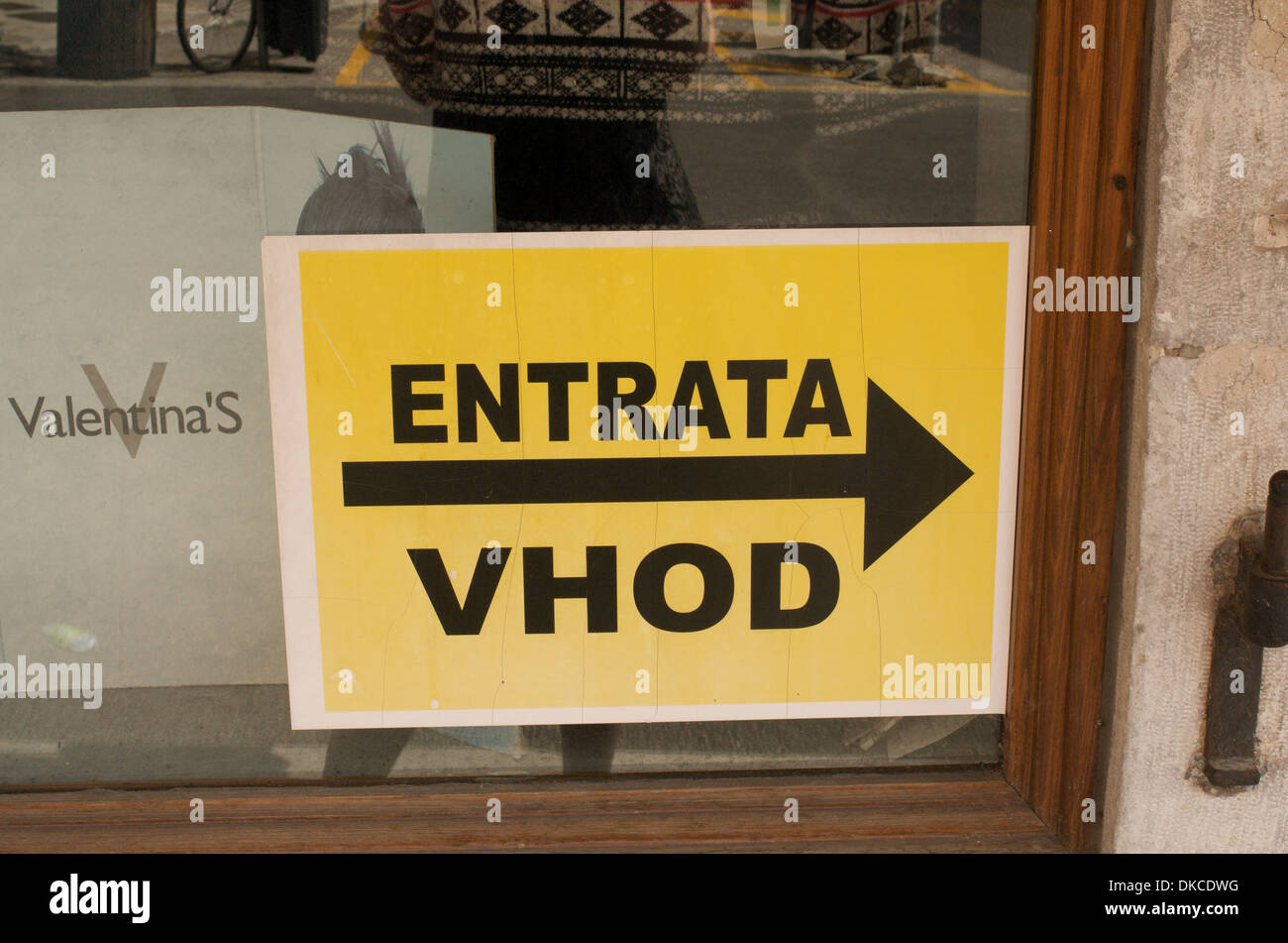 Bilingual shop entrance sign in Italian and Slovene in Gorizia, a town on the border between Italy and Slovenia Stock Photo
