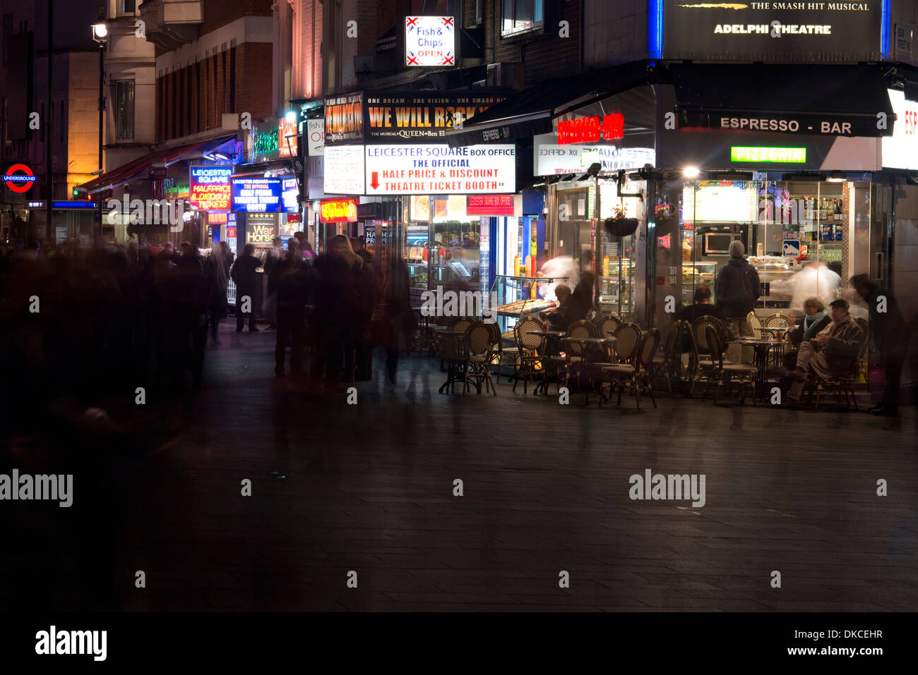 Leicester Square lights people passing by Stock Photo