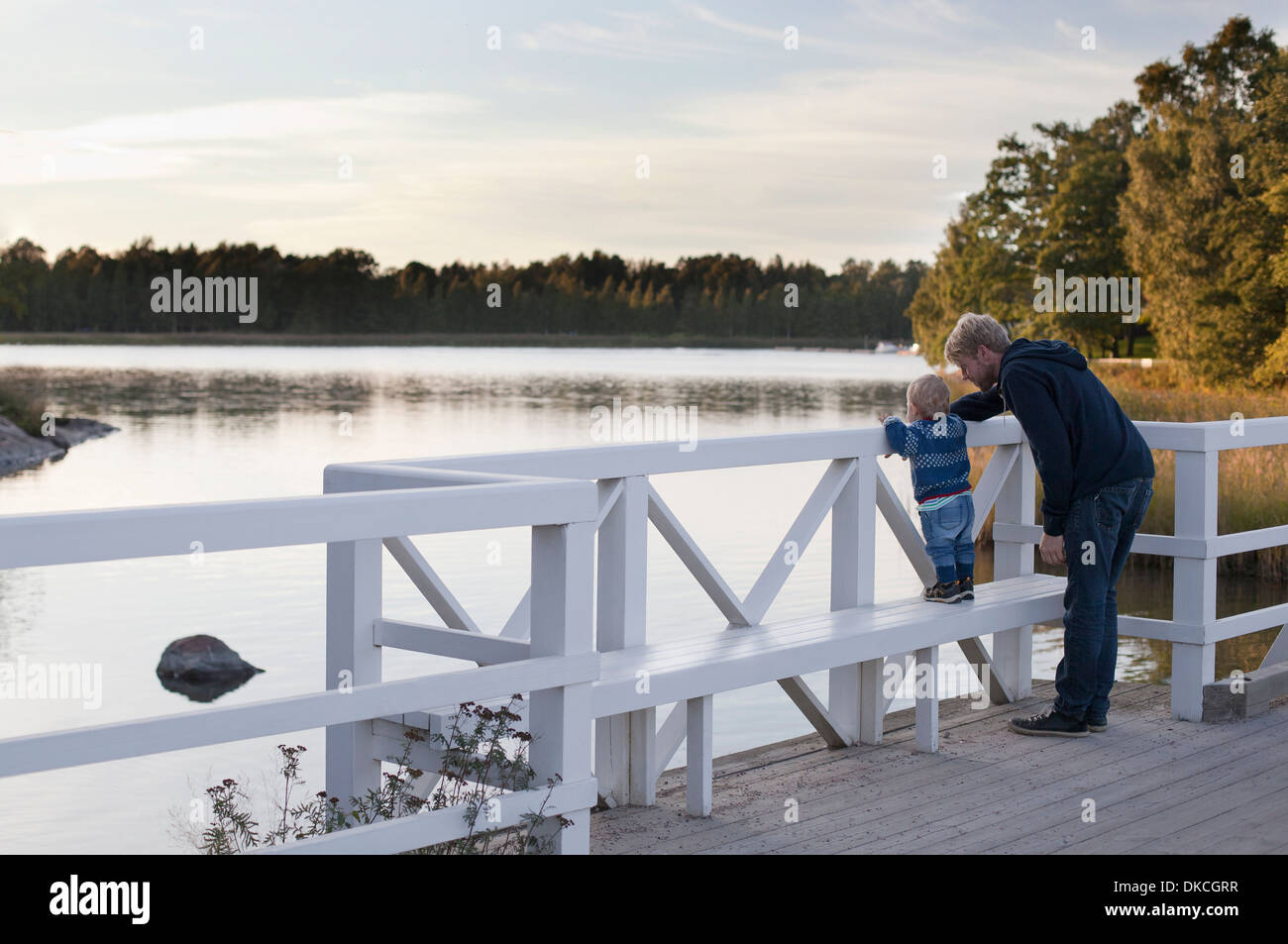 Father and son looking at lake Stock Photo