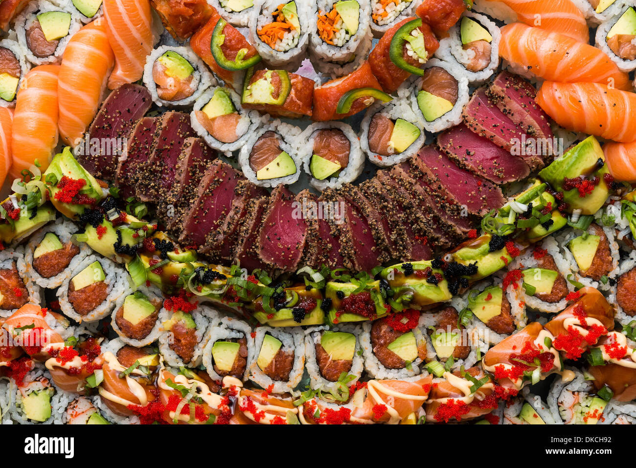 Sushi bar, mix of Sushi, Sashimi, california rolls, Thuna and Salmon slices. Stock Photo