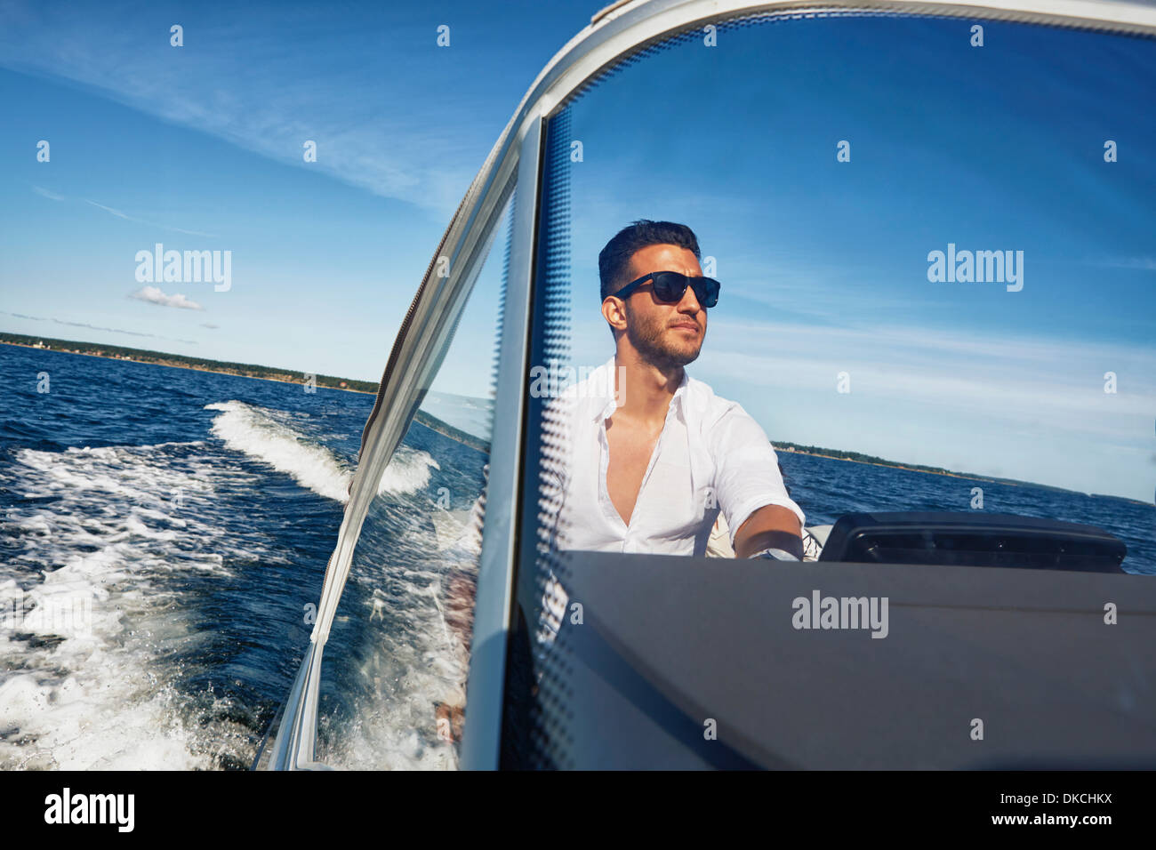 Young man steering boat, Gavle, Sweden Stock Photo - Alamy