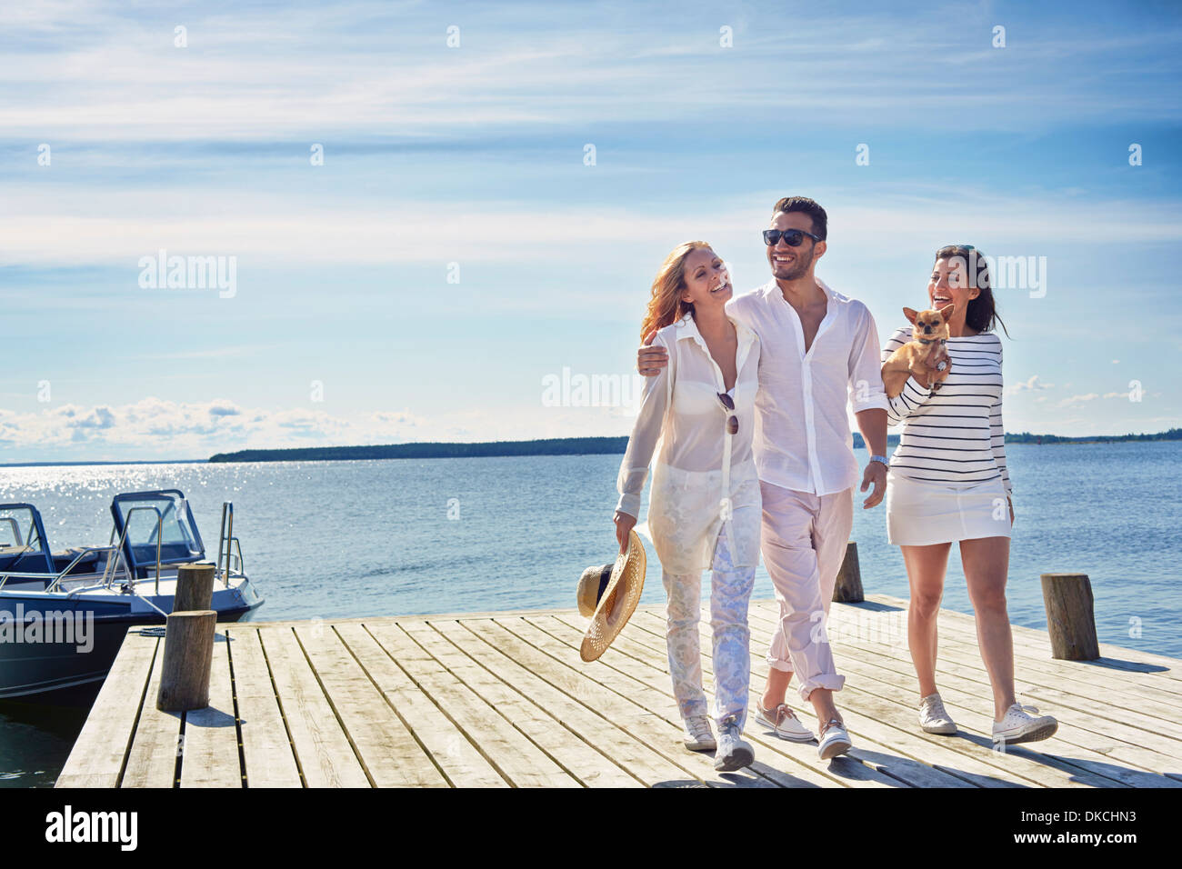 Young adults walking on pier, Gavle, Sweden Stock Photo