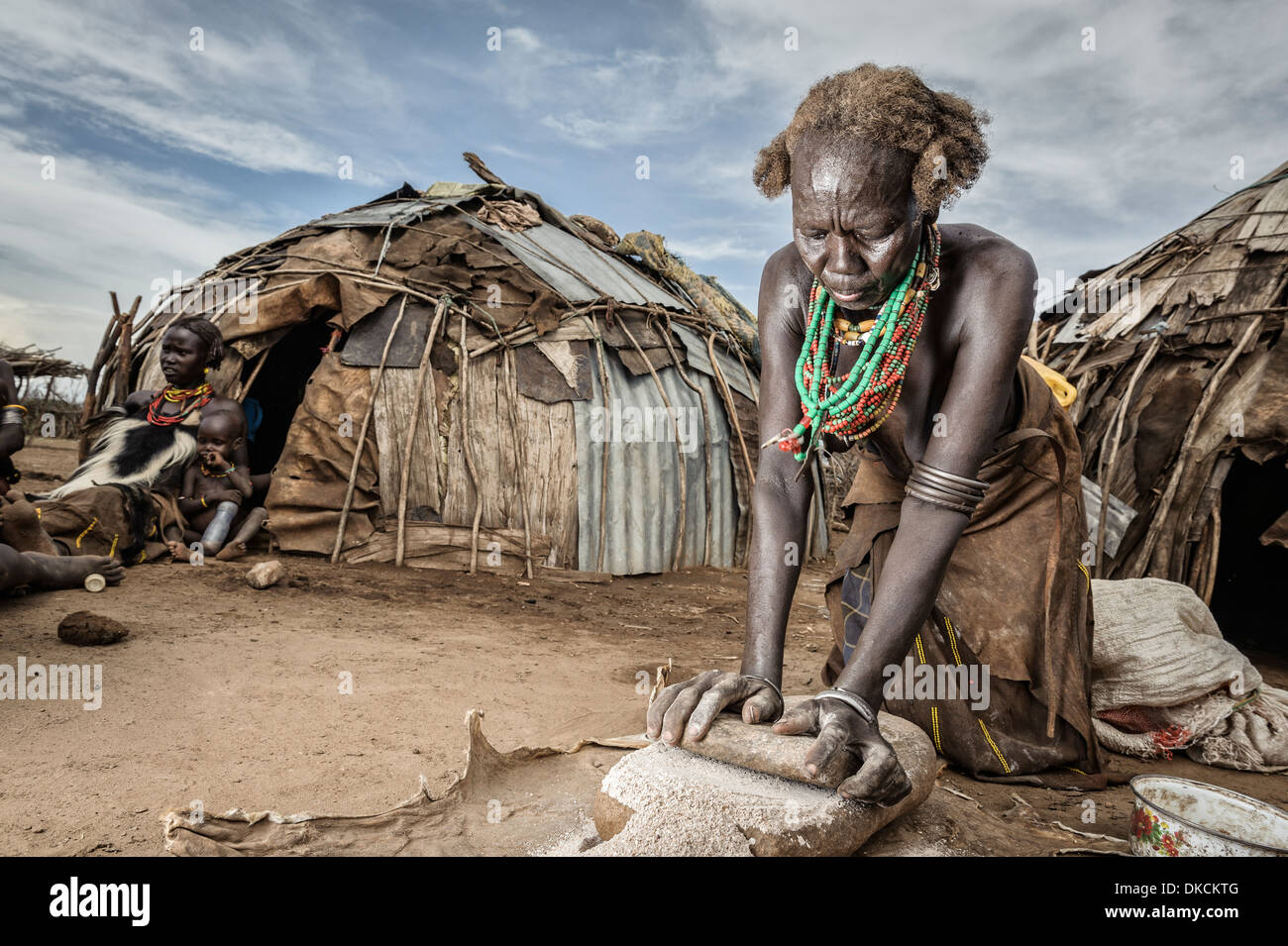 Dassanech woman grinding maize, Omo valley, Ethiopia, Africa Stock Photo