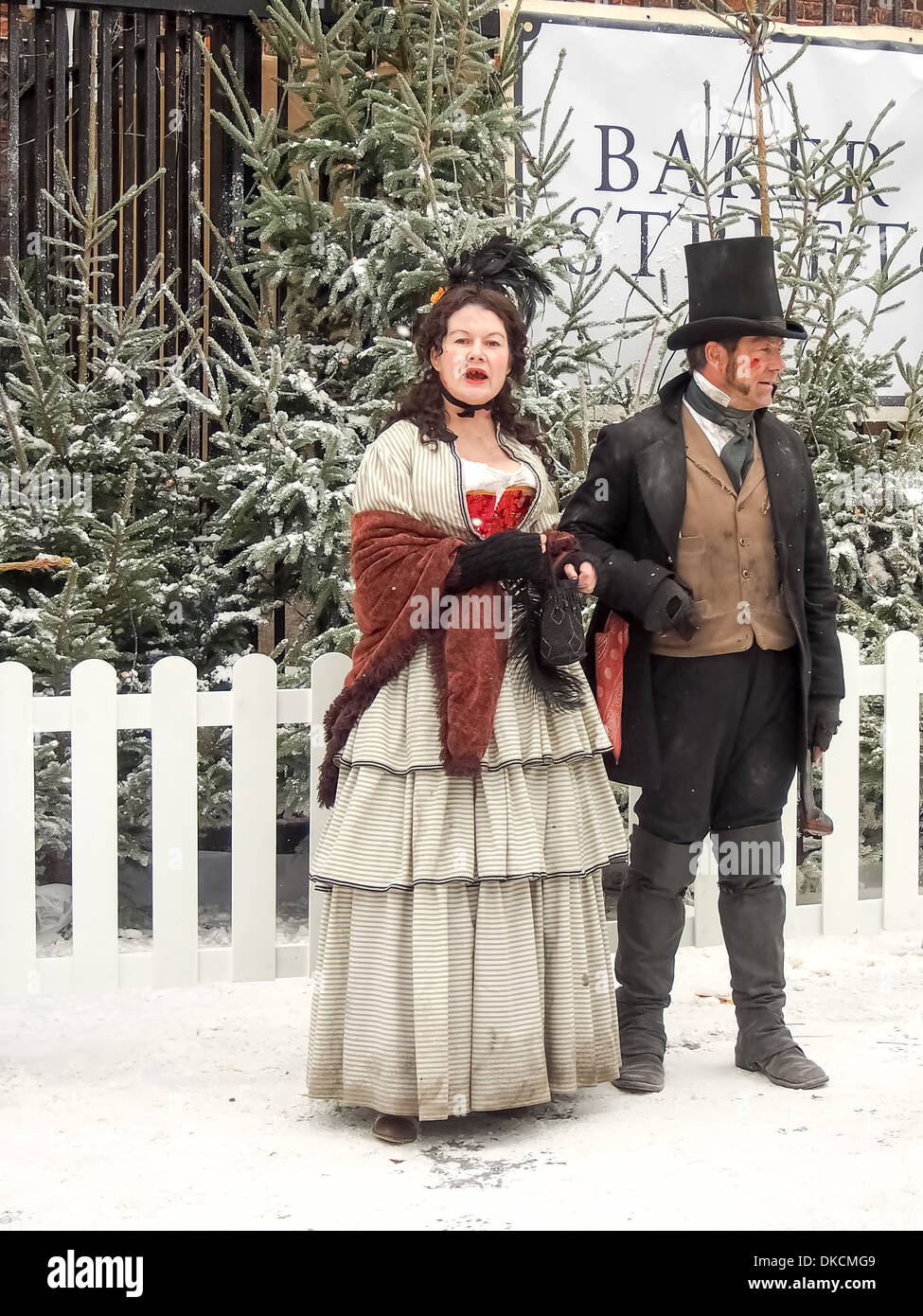 Actors in Victorian costume standing in snow and beside Christmas trees Stock Photo - Alamy