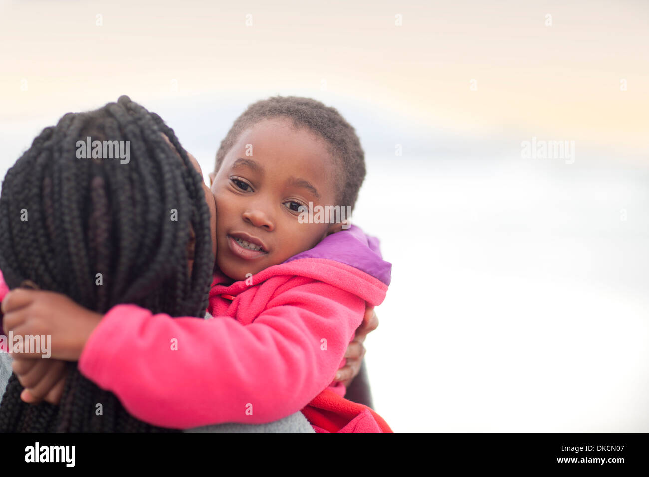 Woman hugging child Stock Photo - Alamy