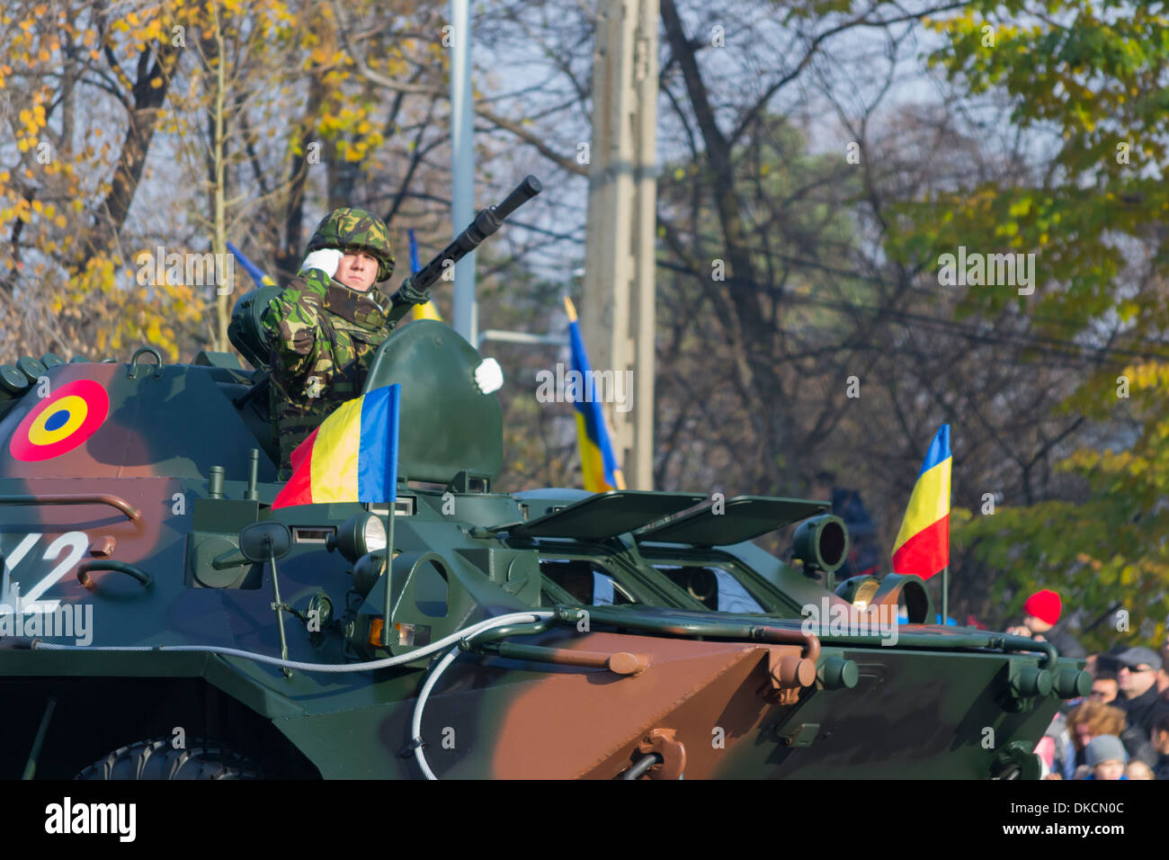 Romanian soldier salutes on a TAB B33 Zimbru armored infantry carrier - December 1st, Parade on Romania's National Day Stock Photo
